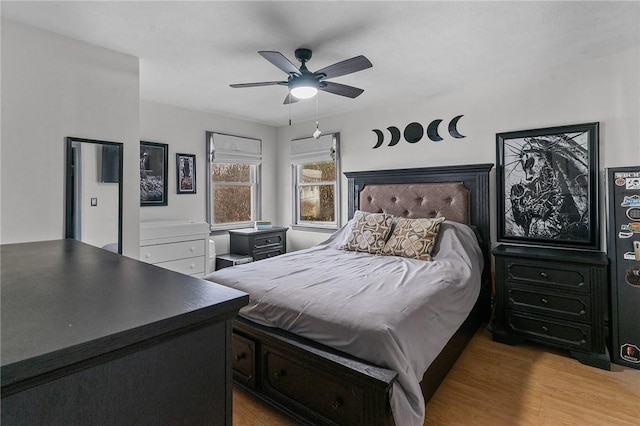 bedroom with ceiling fan and light hardwood / wood-style floors