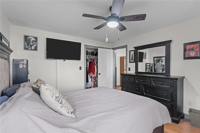 bedroom featuring ceiling fan, a closet, and hardwood / wood-style floors