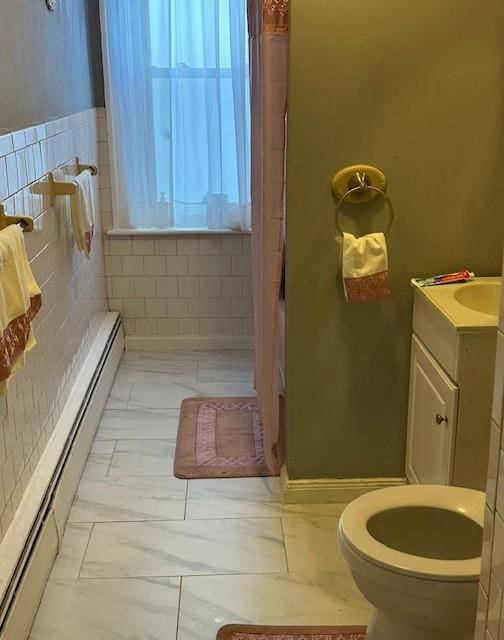 bathroom with vanity, a baseboard radiator, and toilet