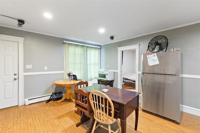 dining area featuring light hardwood / wood-style flooring and a baseboard heating unit