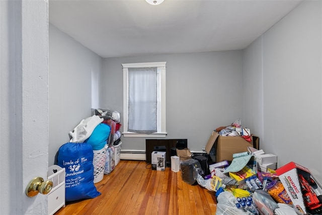 interior space featuring wood-type flooring and a baseboard radiator