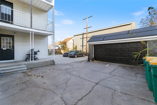 view of patio / terrace featuring a balcony and a garage