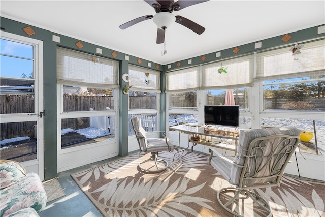 sunroom featuring ceiling fan