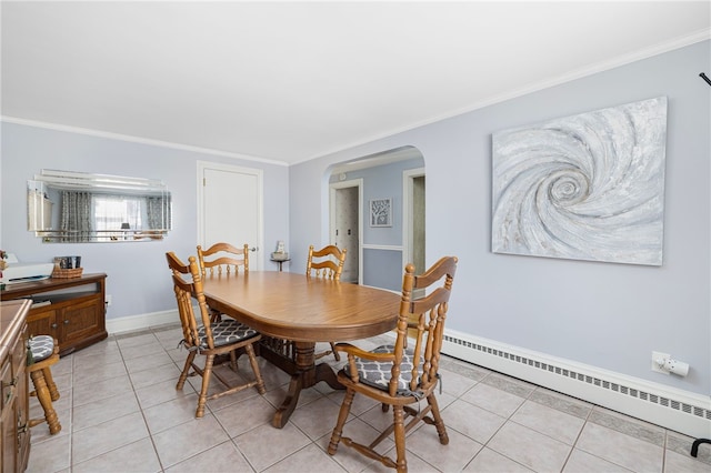 tiled dining area with ornamental molding and a baseboard radiator