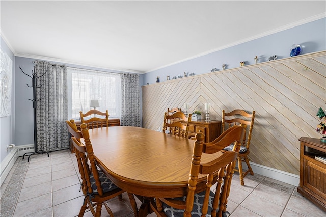 tiled dining room featuring ornamental molding