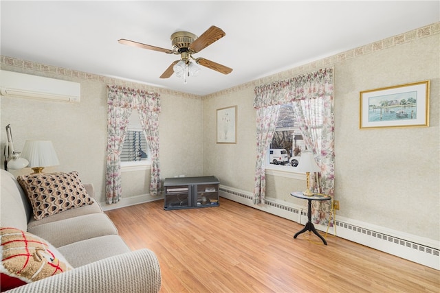 living room featuring baseboard heating, ceiling fan, wood-type flooring, and a wall mounted air conditioner