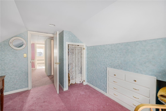 carpeted bedroom with lofted ceiling