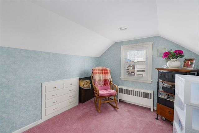 sitting room with light colored carpet, radiator, and vaulted ceiling