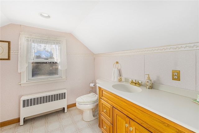 bathroom with vanity, toilet, radiator, and vaulted ceiling