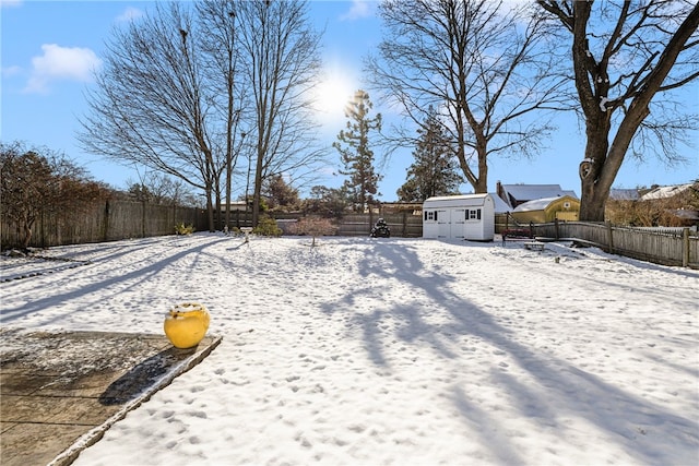 snowy yard with a storage unit