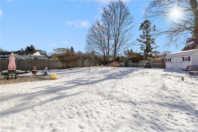 snowy yard with a storage unit