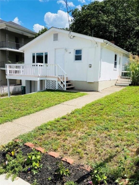 rear view of house featuring a yard