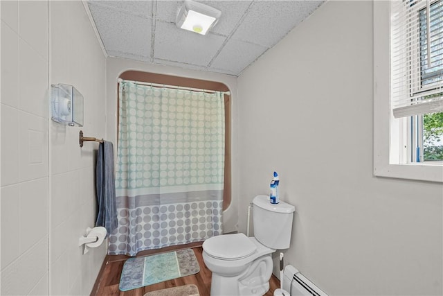 bathroom featuring a paneled ceiling, toilet, a baseboard heating unit, and hardwood / wood-style flooring