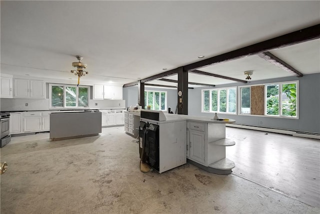 kitchen with a center island, stove, a baseboard heating unit, beam ceiling, and white cabinetry