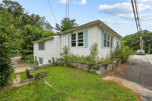 view of home's exterior featuring a lawn