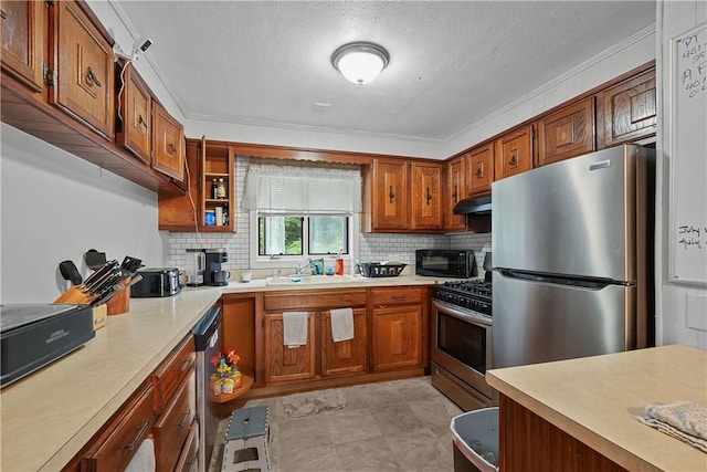 kitchen with crown molding, sink, and appliances with stainless steel finishes