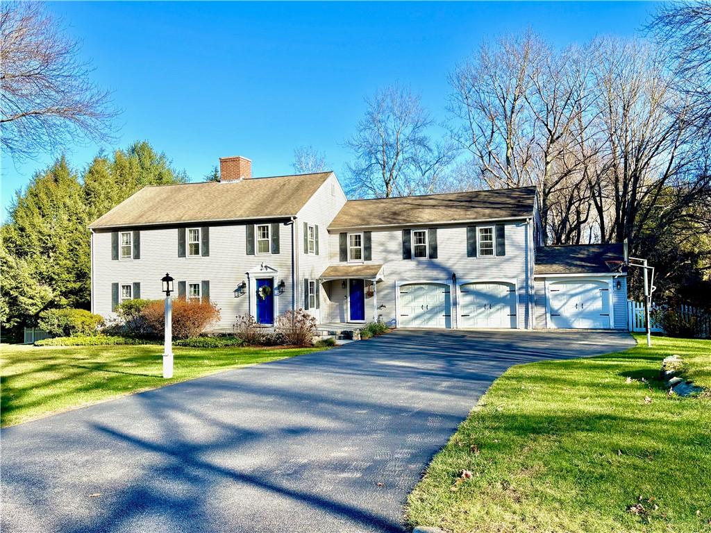 view of front of home with a garage and a front lawn