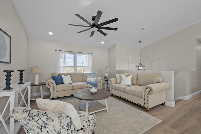 living room featuring light hardwood / wood-style flooring and ceiling fan