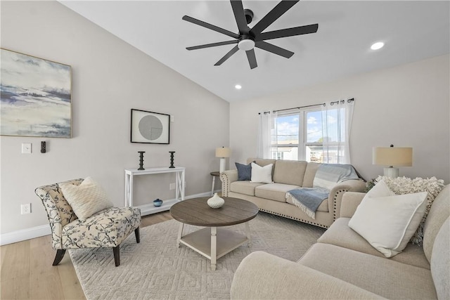 living room featuring light hardwood / wood-style flooring, ceiling fan, and lofted ceiling