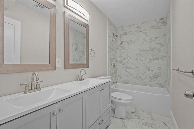 full bathroom with vanity, toilet, and tiled shower / bath