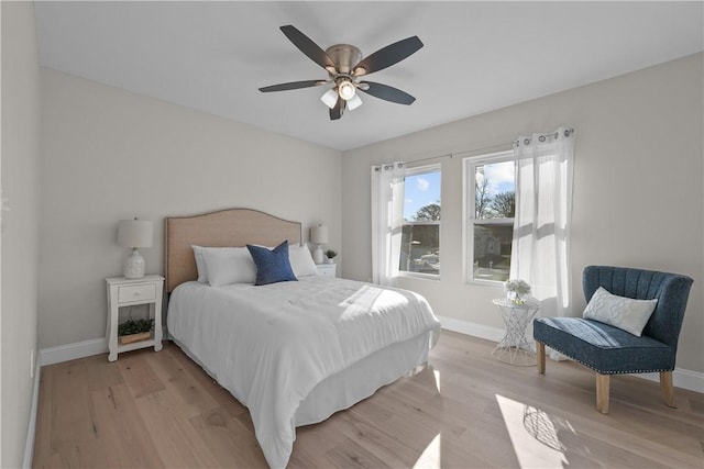 bedroom with ceiling fan and light hardwood / wood-style floors