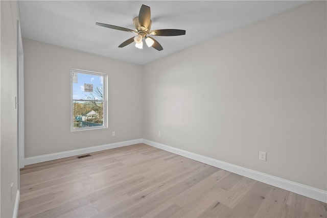 spare room with ceiling fan and light hardwood / wood-style floors