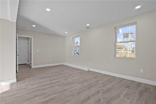 spare room with light hardwood / wood-style flooring