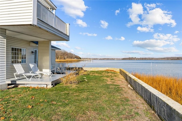 view of yard with a deck with water view