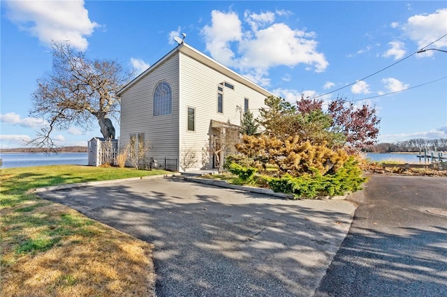 view of property exterior with a water view