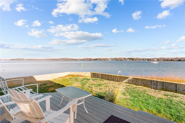 wooden deck featuring a lawn and a water view