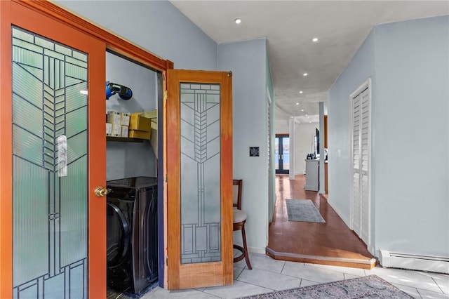 corridor with light tile patterned flooring and a baseboard radiator