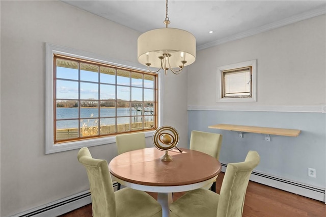 dining space featuring a chandelier, a water view, ornamental molding, and a baseboard radiator