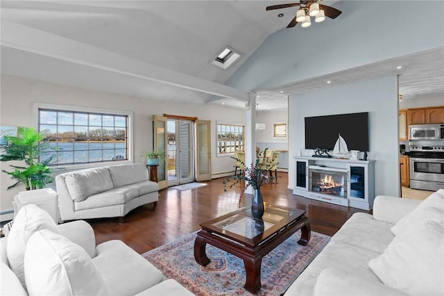 living room with ceiling fan, vaulted ceiling, dark hardwood / wood-style floors, and a baseboard heating unit