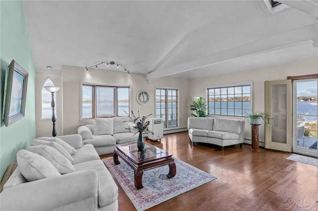 living room with dark hardwood / wood-style floors, a water view, lofted ceiling, and a baseboard heating unit