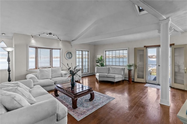 living room with vaulted ceiling, decorative columns, a baseboard radiator, and dark wood-type flooring