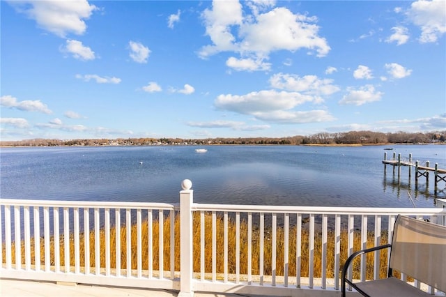 wooden terrace featuring a boat dock and a water view