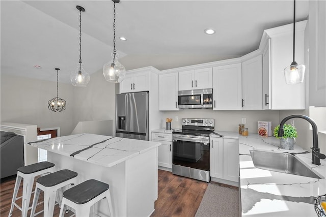 kitchen with white cabinetry, sink, a kitchen island, and stainless steel appliances