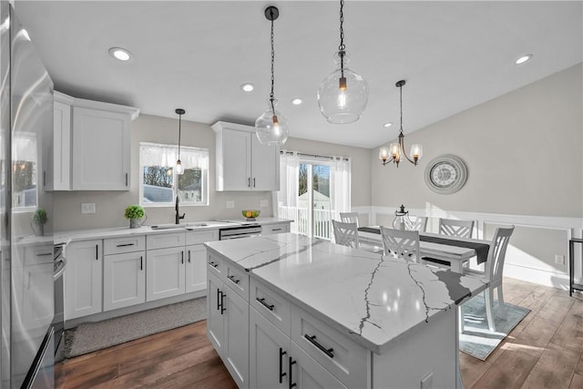 kitchen featuring white cabinets, dark hardwood / wood-style floors, a kitchen island, and sink