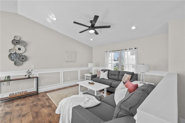 living room featuring vaulted ceiling, ceiling fan, and dark wood-type flooring