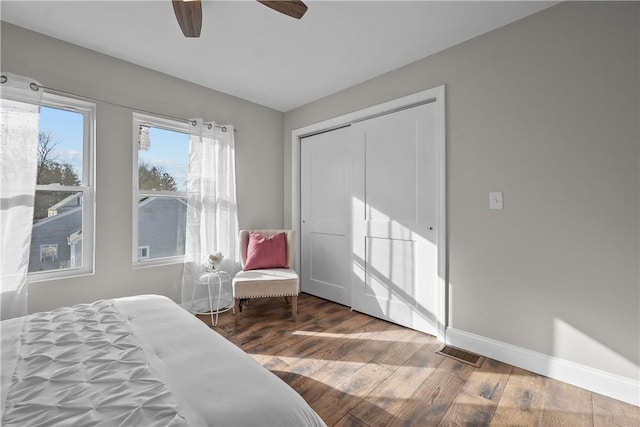 bedroom featuring ceiling fan, a closet, and hardwood / wood-style flooring