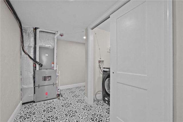 laundry room featuring washer / clothes dryer and heating unit