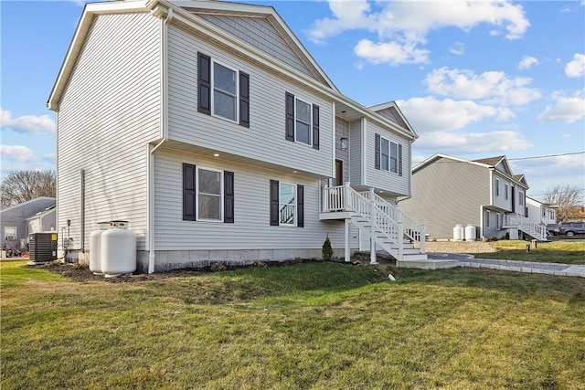 view of front of house featuring a front lawn and central AC unit