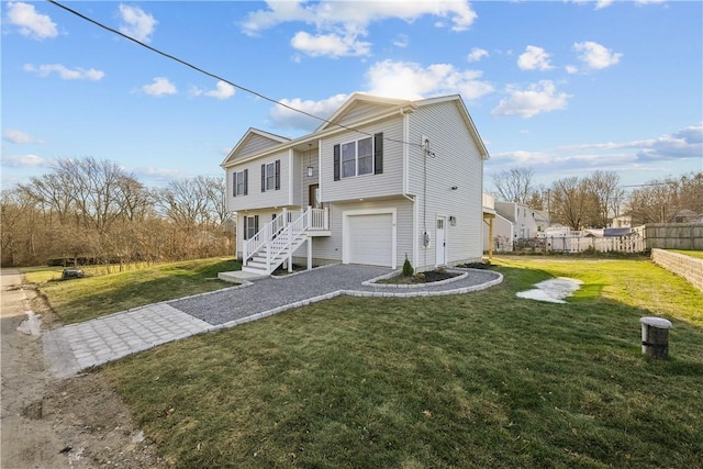 view of front of home featuring a garage and a front lawn