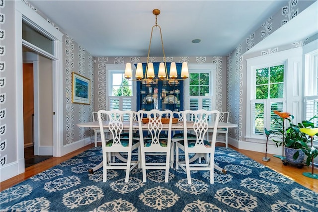 dining area featuring a chandelier, hardwood / wood-style flooring, and a wealth of natural light