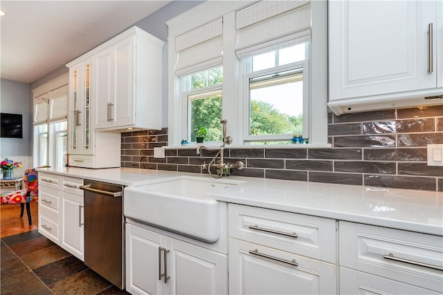 kitchen with white cabinets, dishwasher, backsplash, and sink