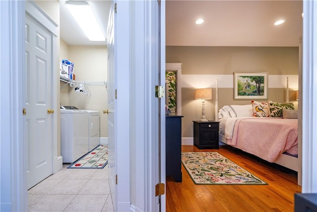 bedroom featuring washer and dryer and light wood-type flooring