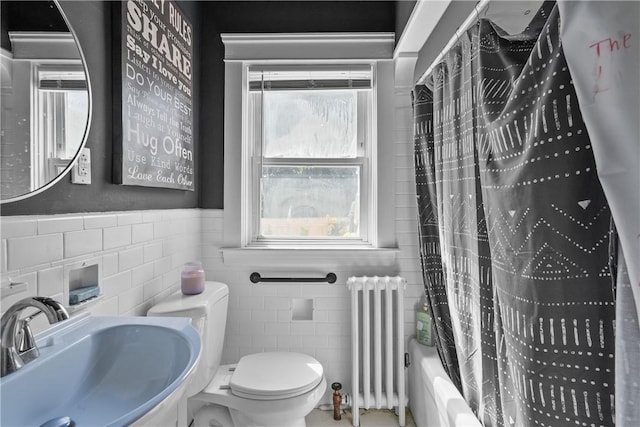 full bathroom with shower / bath combo, radiator, sink, toilet, and tile walls