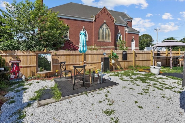 rear view of property with a gazebo and a patio area