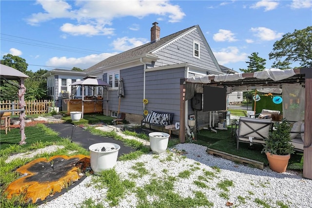 back of property featuring a gazebo