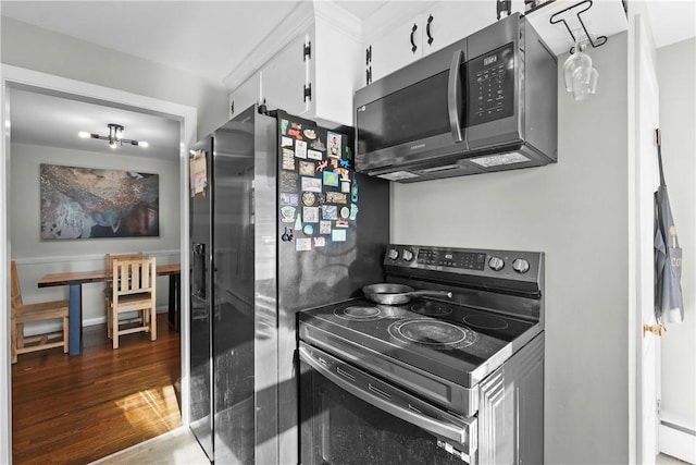 kitchen with dark hardwood / wood-style flooring, white cabinetry, and appliances with stainless steel finishes